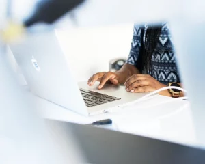 Cover-Bild: Top 5 Gründungsberatungen Blick auf eine Laptoptatstatur, an der eine Person tippt.
